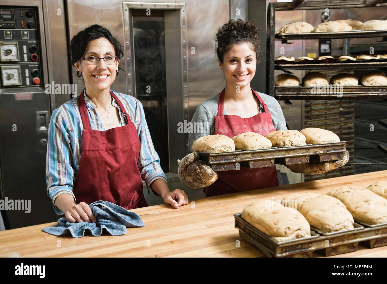 Female bakers working at a bakery with loaves of bread Stock Photo Alamy