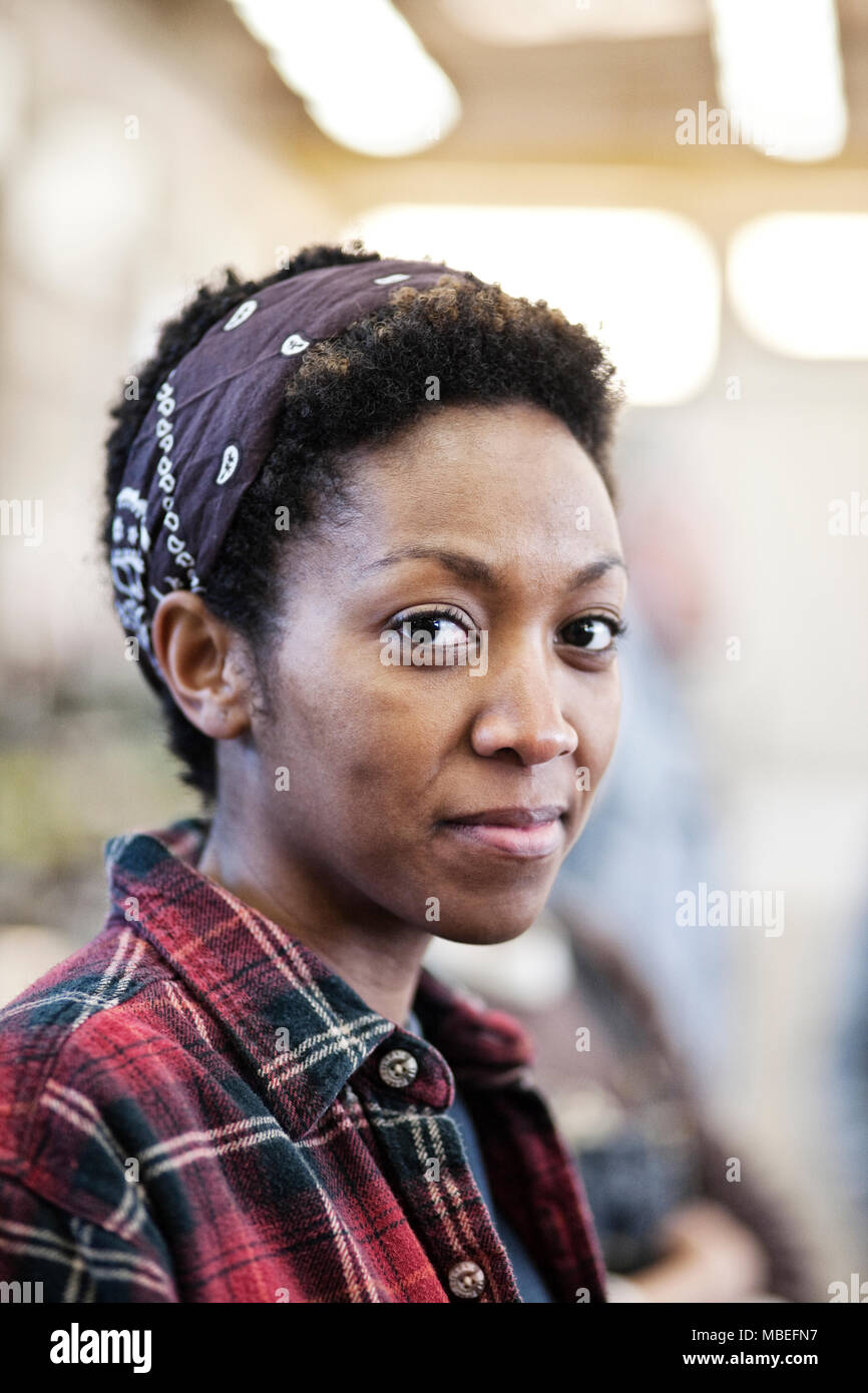 Black woman wearing a bandana in a factrory Stock Photo - Alamy