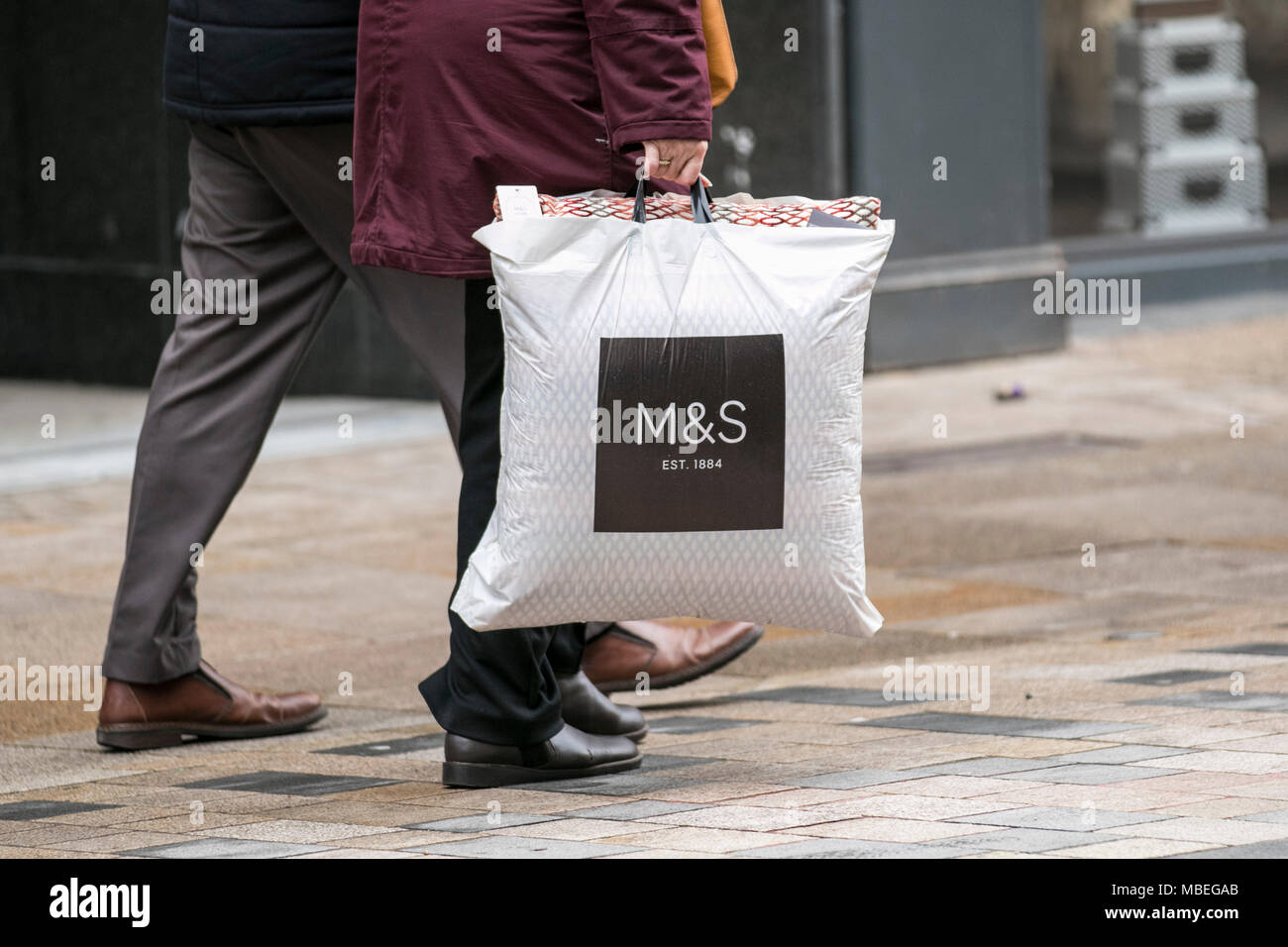 M&S spring sales with shoppers carrying reusable bags in Preston city centre, UK Stock Photo