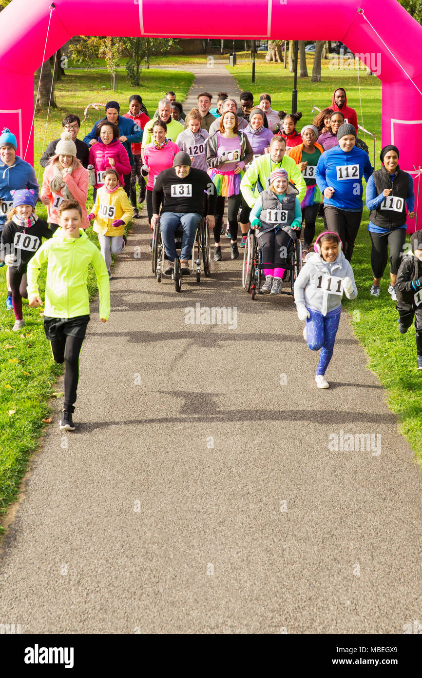 Runners starting at charity run in park Stock Photo