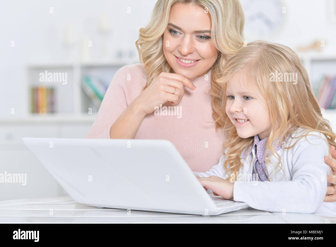 young woman and little girl using laptop Stock Photo - Alamy