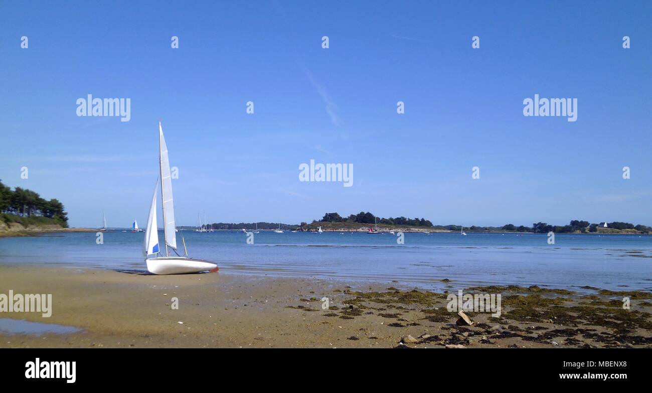 Sailboat stranded on a beach of Ile aux moines in Gulf of Morbihan, Brittany, France Stock Photo