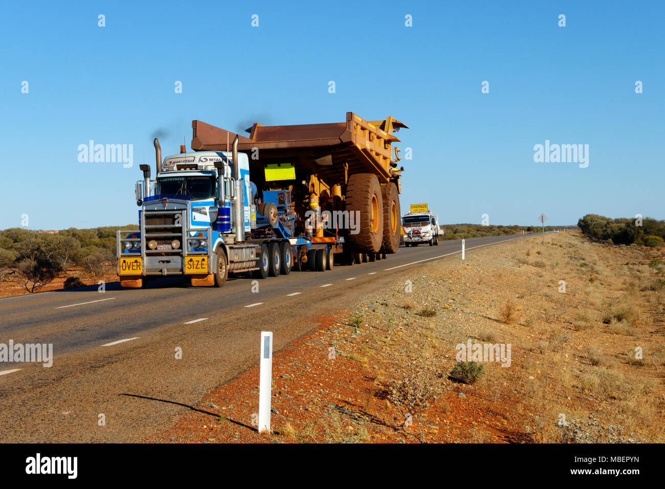 Oversized dump truck being transported on the great northern highway, Northern Goldfields, Western Australia Stock Photo