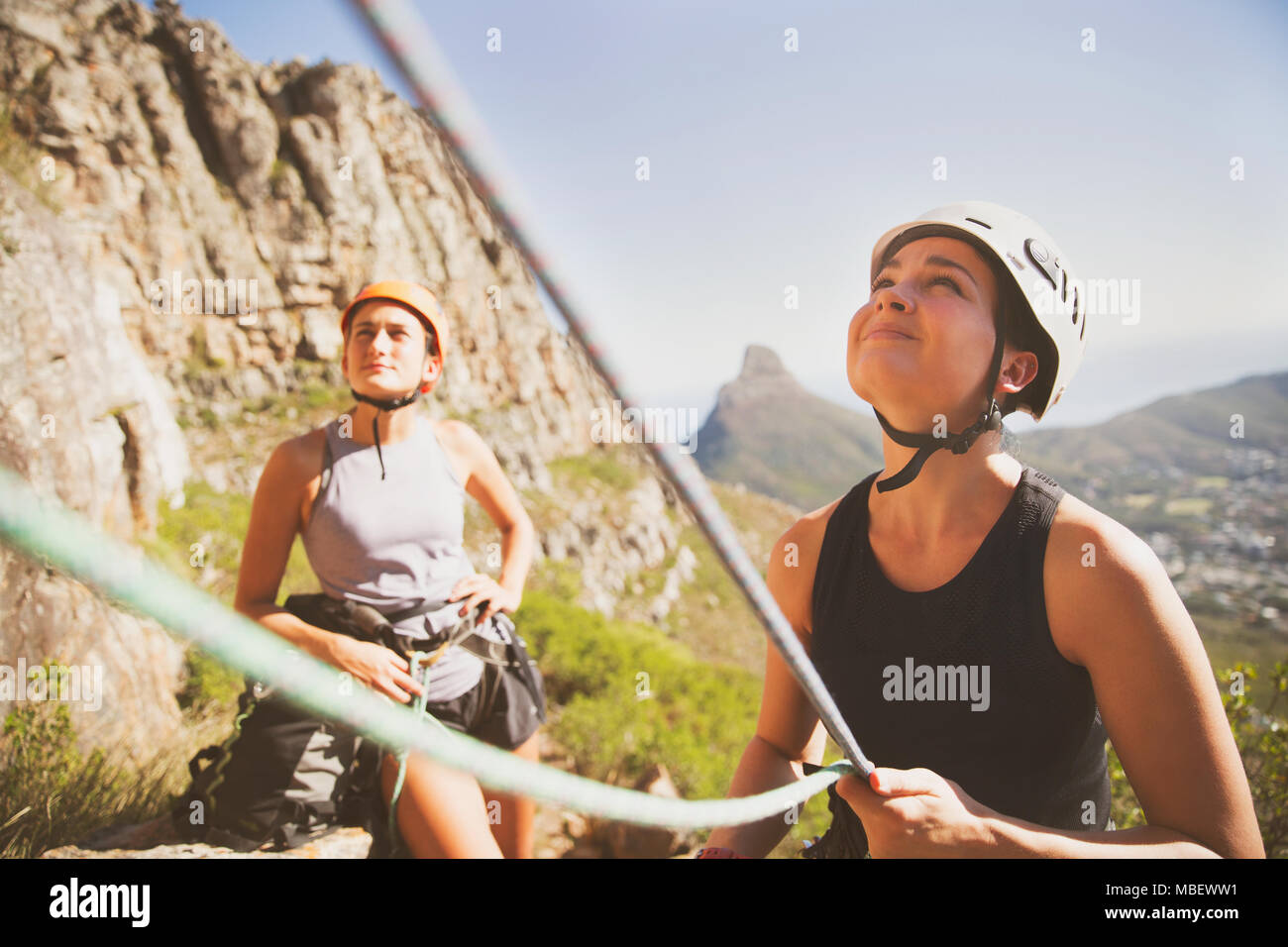 Female rock climber holding ropes Stock Photo