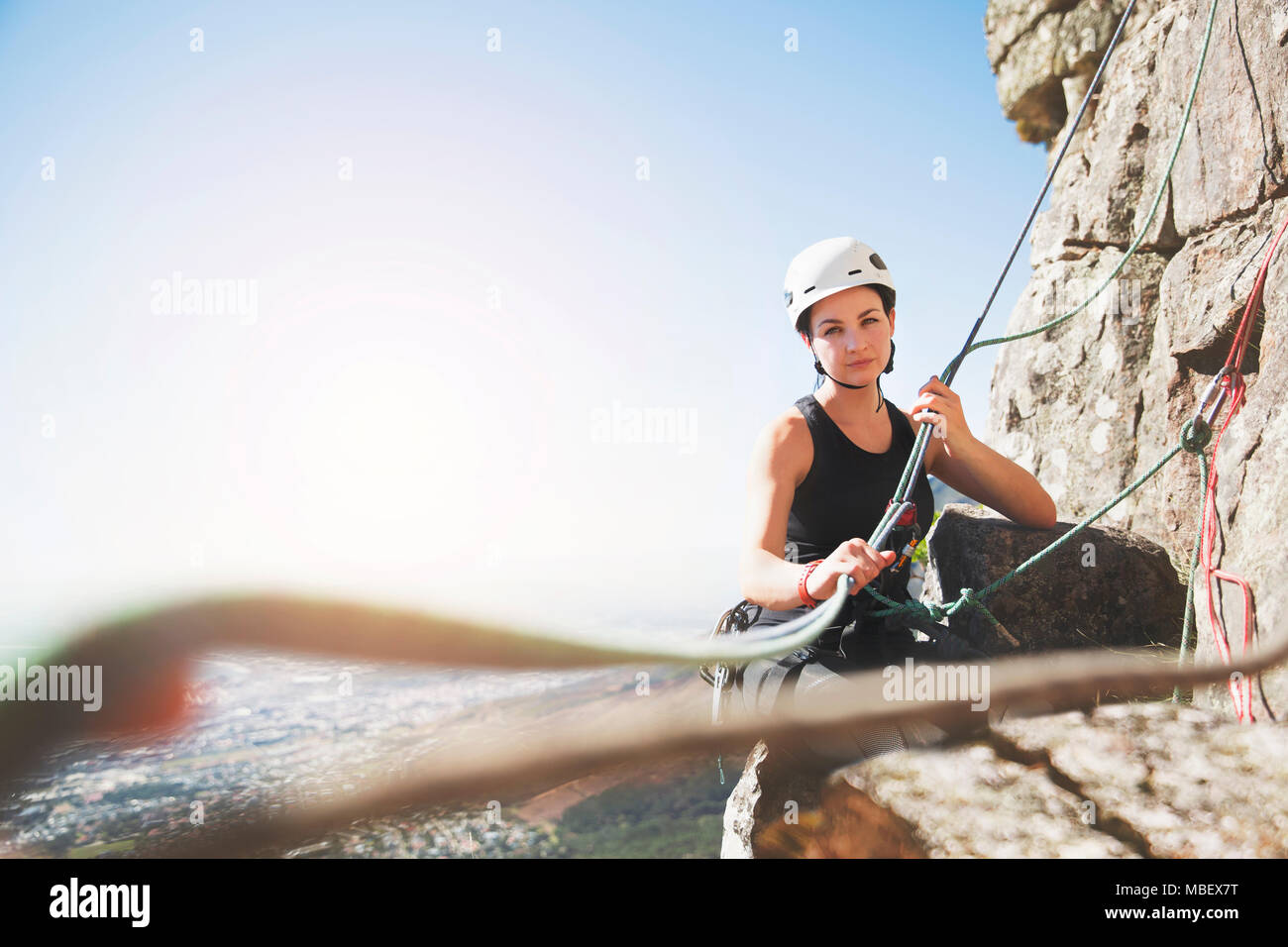 Portrait confident female rock climber with ropes Stock Photo