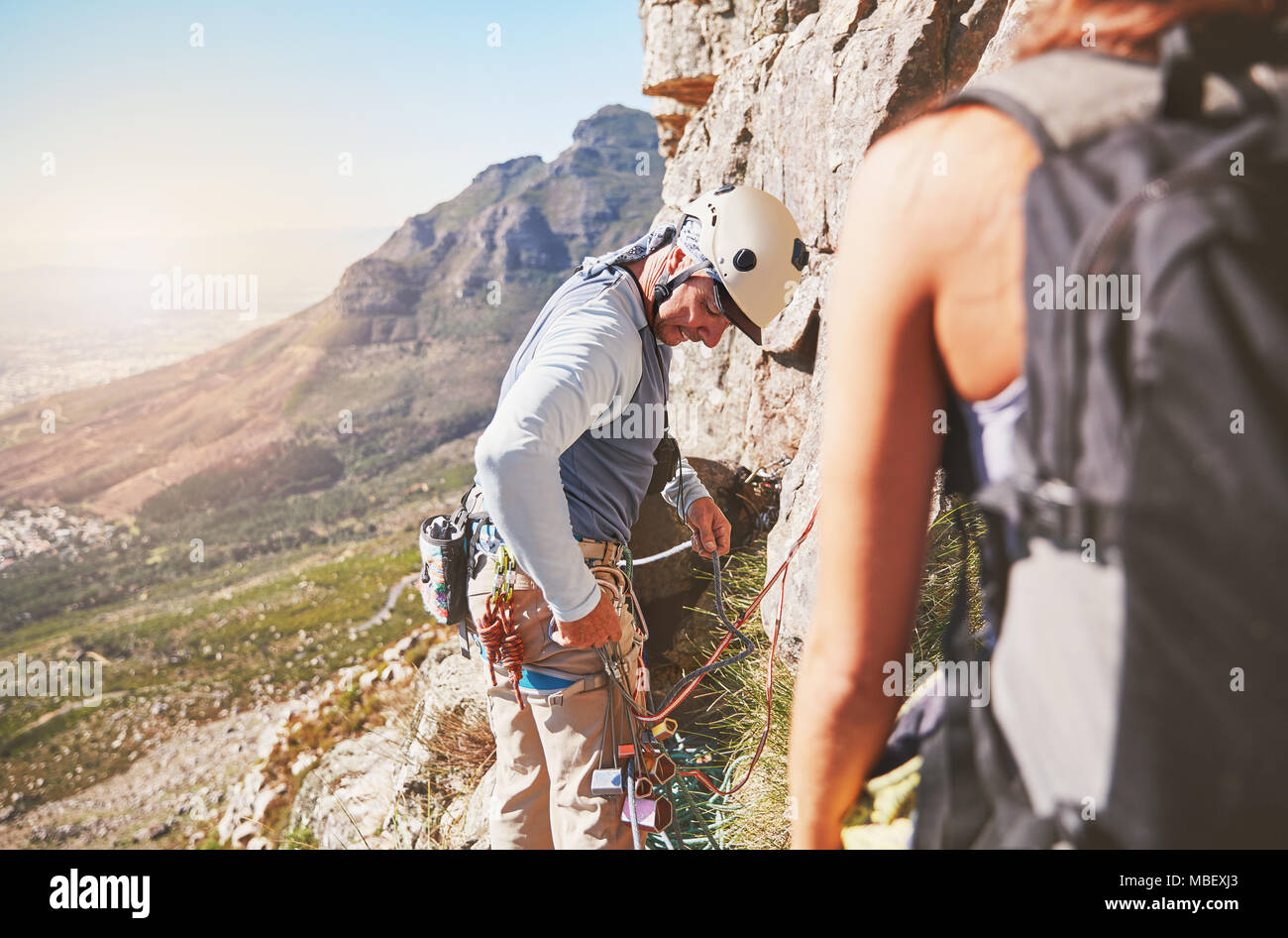 Male rock climber checking equipment Stock Photo