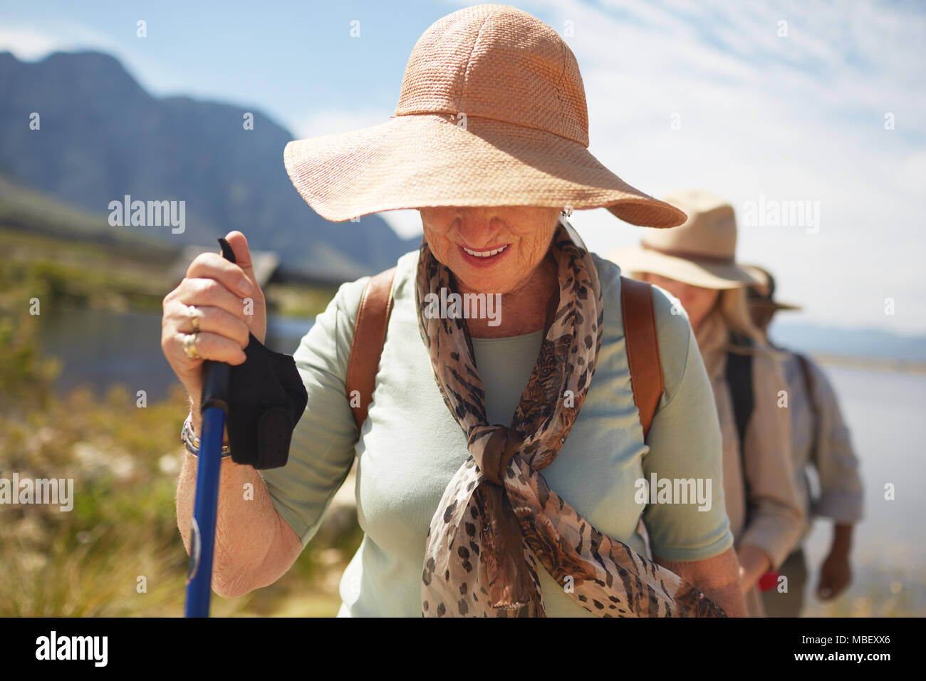 Active senior woman in sun hat hiking Stock Photo