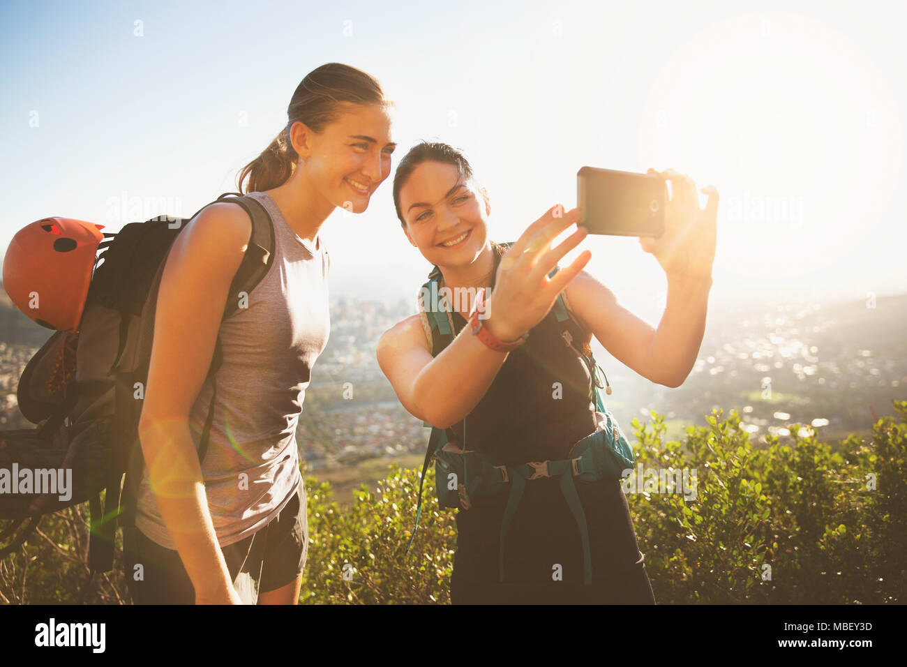 Female rock climbers taking selfie with camera phone Stock Photo