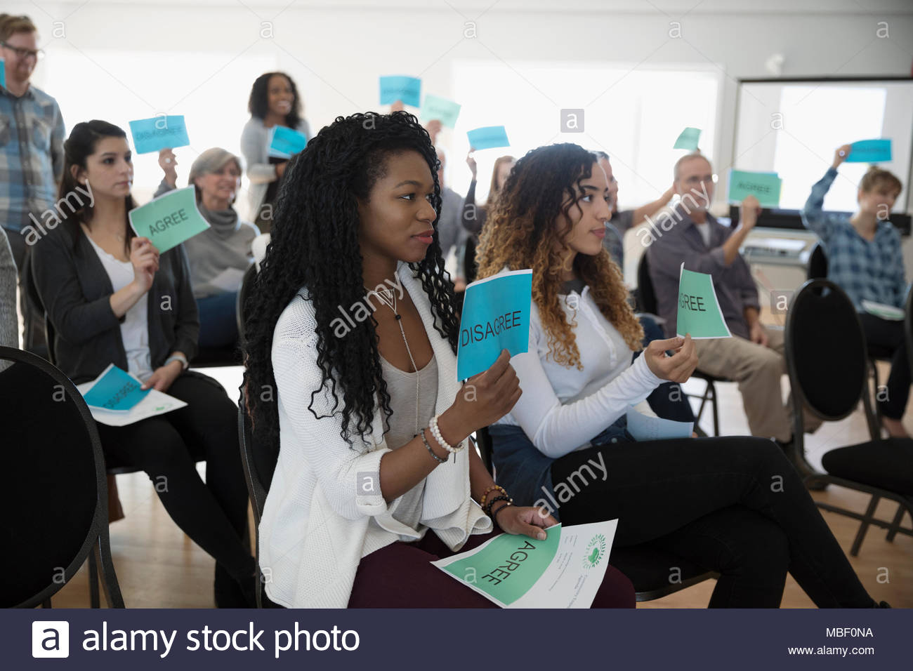Audience voting at town hall meeting Stock Photo