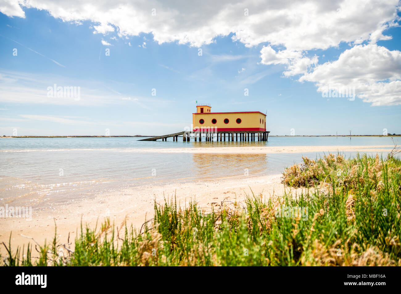 Sunny beach view of the historical life-guard building in Fuseta, Ria Formosa Natural park, Portugal Stock Photo