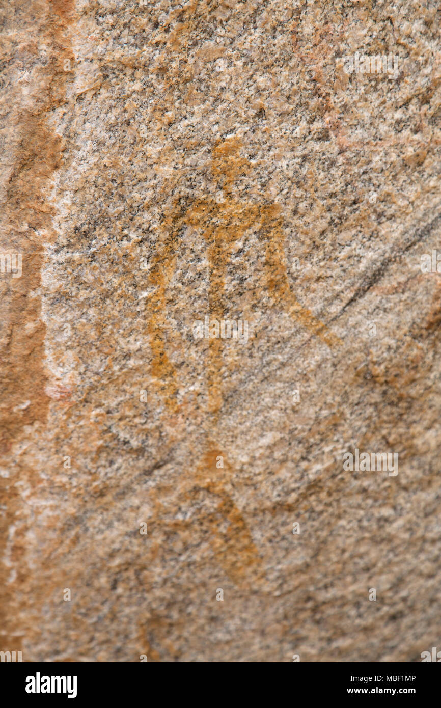 Ancient rock art at Matobo National Park in Zimbabwe. The painting depicts a human form. Stock Photo