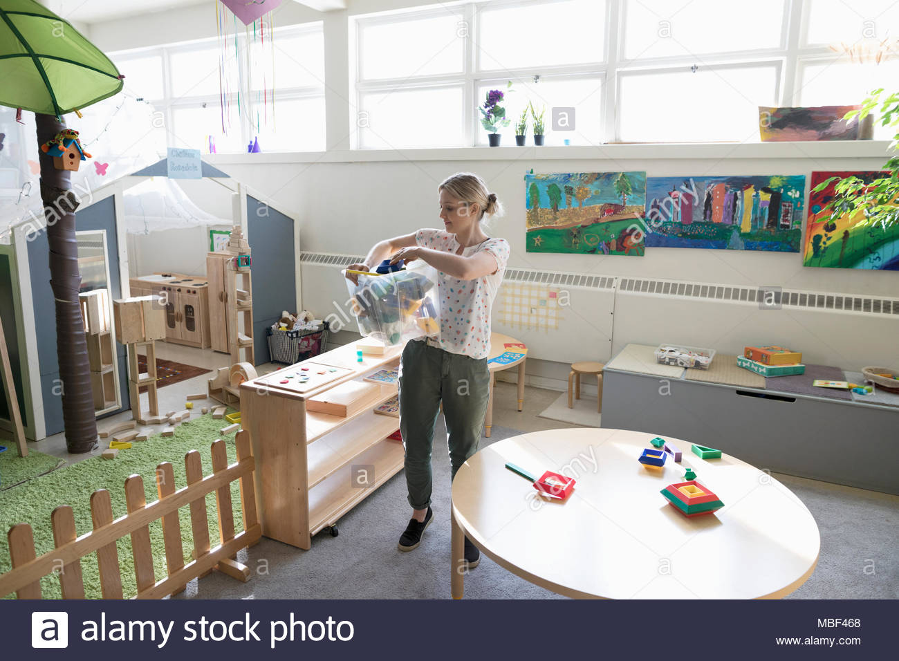 Preschool teacher cleaning classroom Stock Photo Alamy