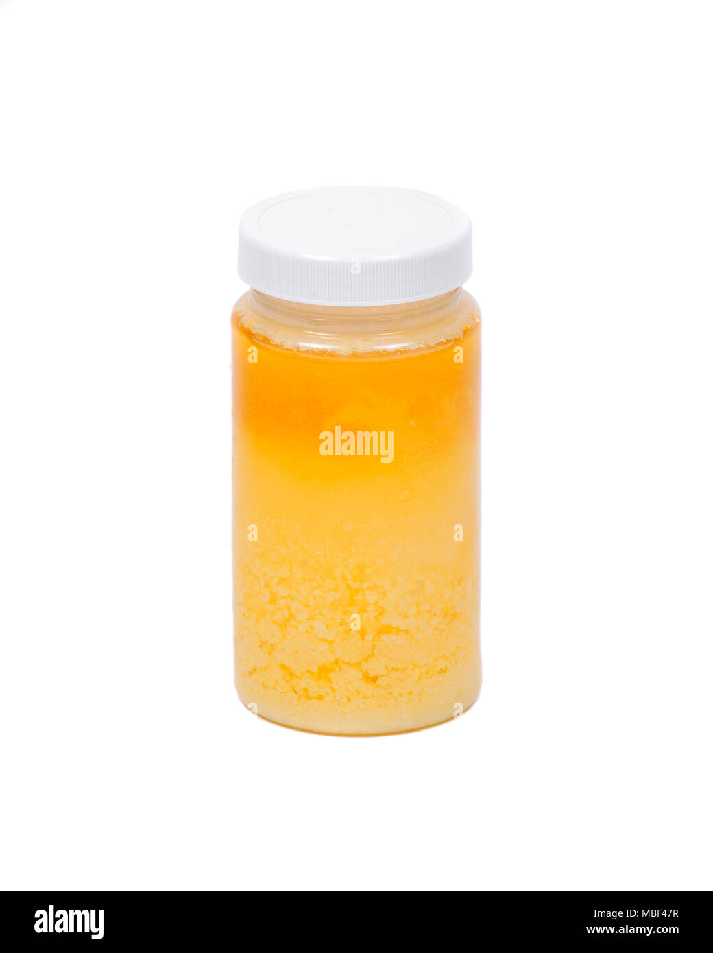 Clarified butter ghee in plastic jar Stock Photo