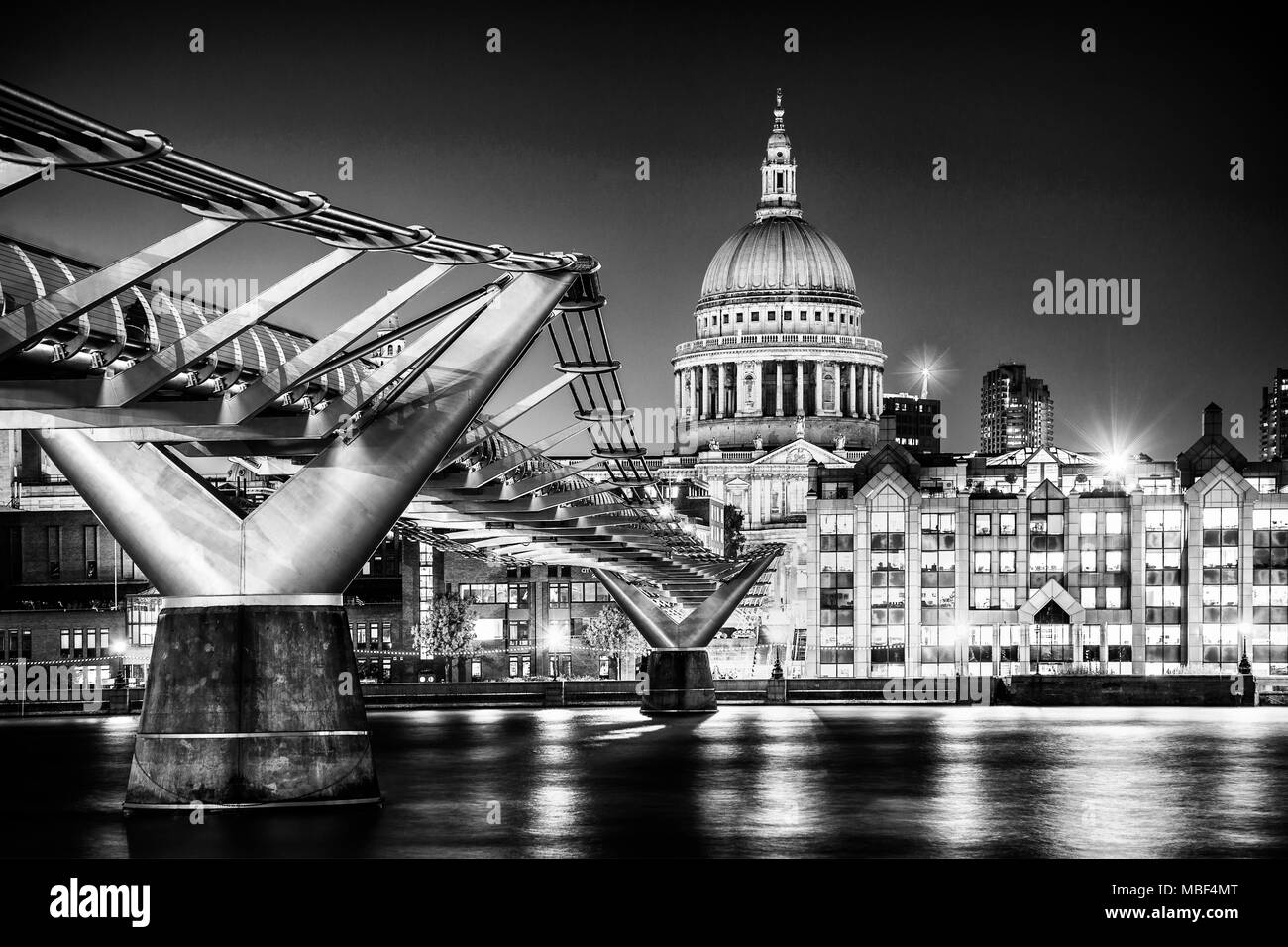 The Millennium Bridge and St. Paul's Cathedral in London at twilight. Stock Photo