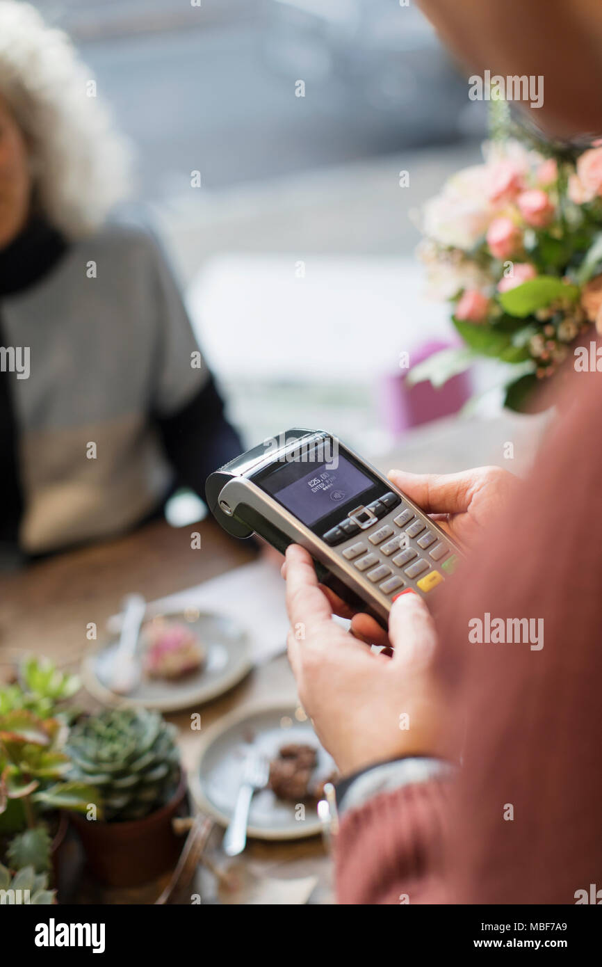 Cashier with credit card reader in cafe Stock Photo - Alamy