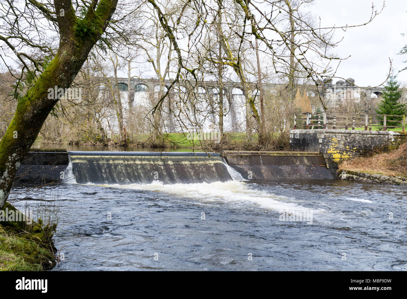 The weir below Lake Vrynwy in Powys, Wales, on a bright spring day ...