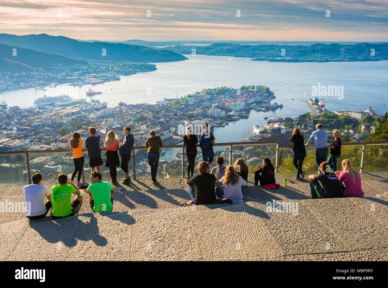 Tourists view the city of Bergen, Norway from Floyen mountain at sunset Stock Photo