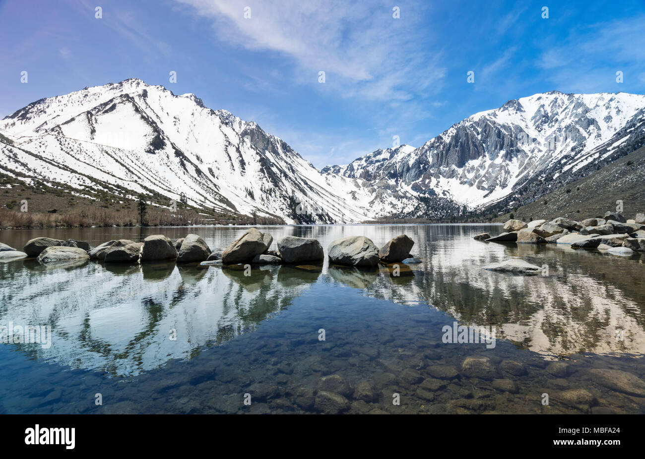 Reflection of snow covered mountains in a calm Convict Lake in Sierra Nevada California, USA Stock Photo