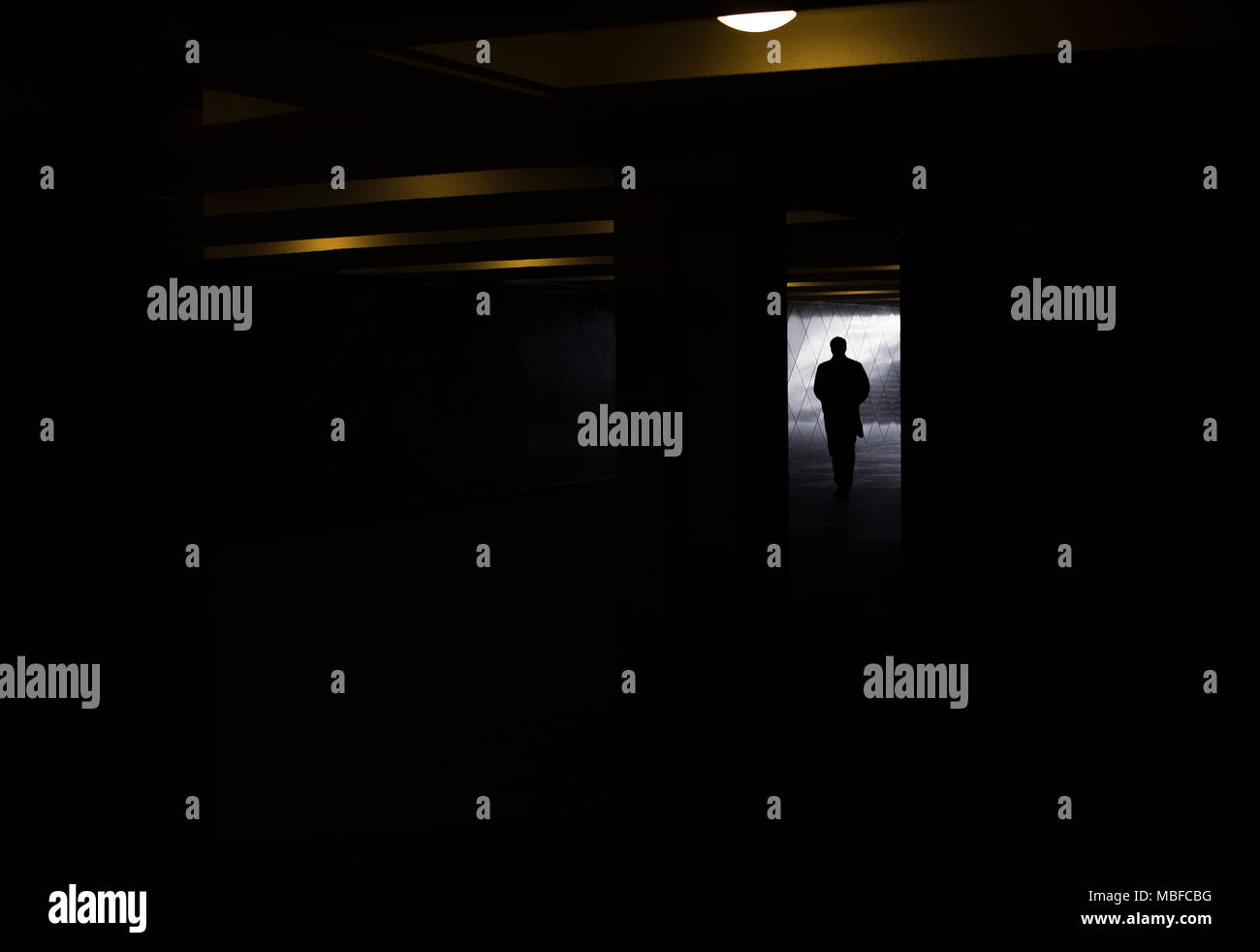 A silhouette of a man in a dark tunnel Stock Photo - Alamy