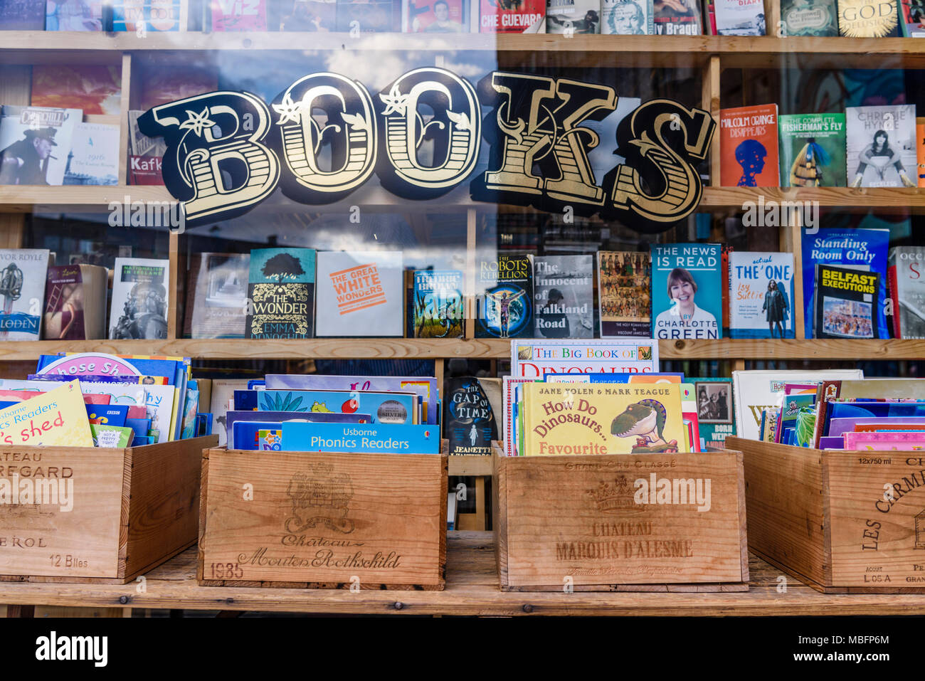 Trendy book shop with books in old French wooden boxes. Stock Photo