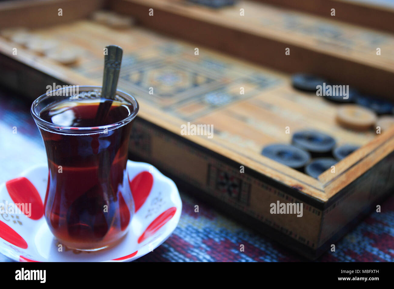 Glass of Turkish tea and Backgammon game board Stock Photo - Alamy