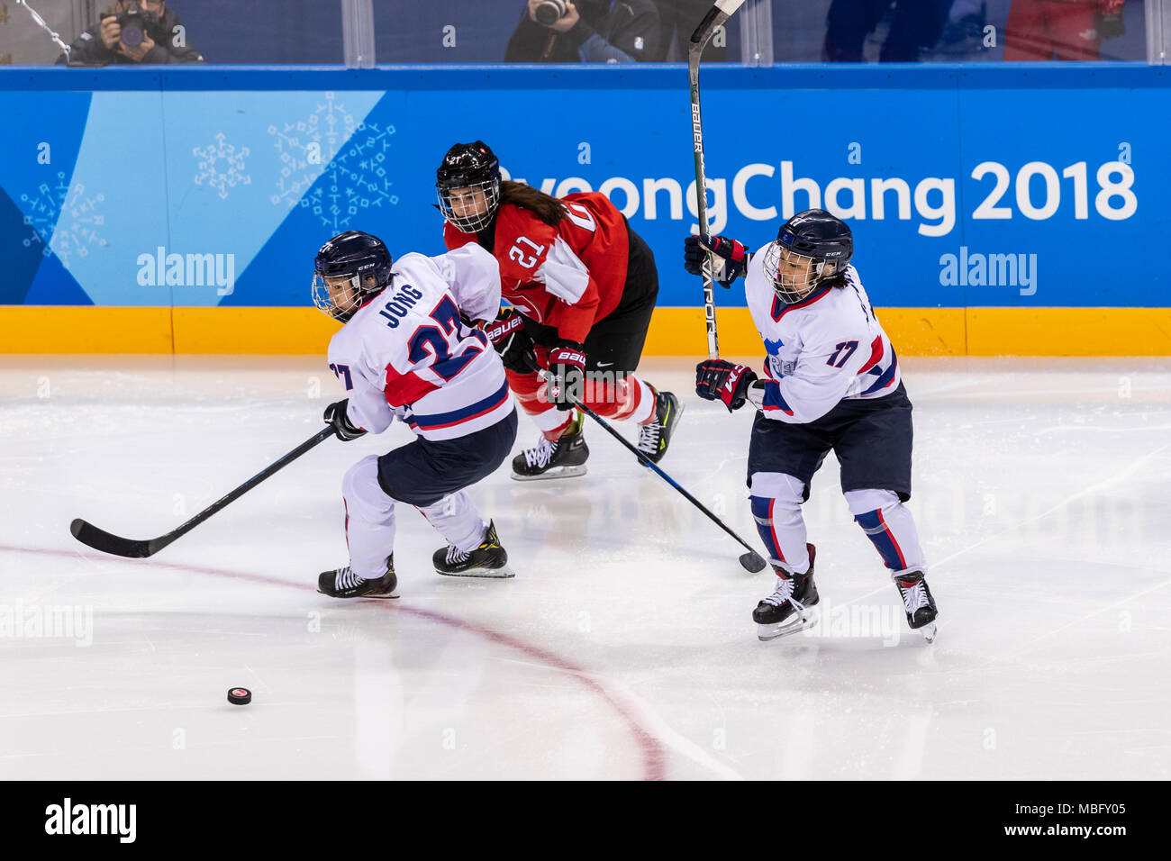 Su Hyon Jong (KOR) #27, Laura Benz (SUI) #21 and Soojin Han (KOR) #17 during Korea (combinded) vs Switzerland Women's Ice Hockey competition at the Ol Stock Photo