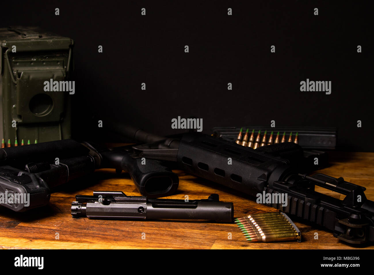 AR-15 broken down in dark setting with ammunition Stock Photo