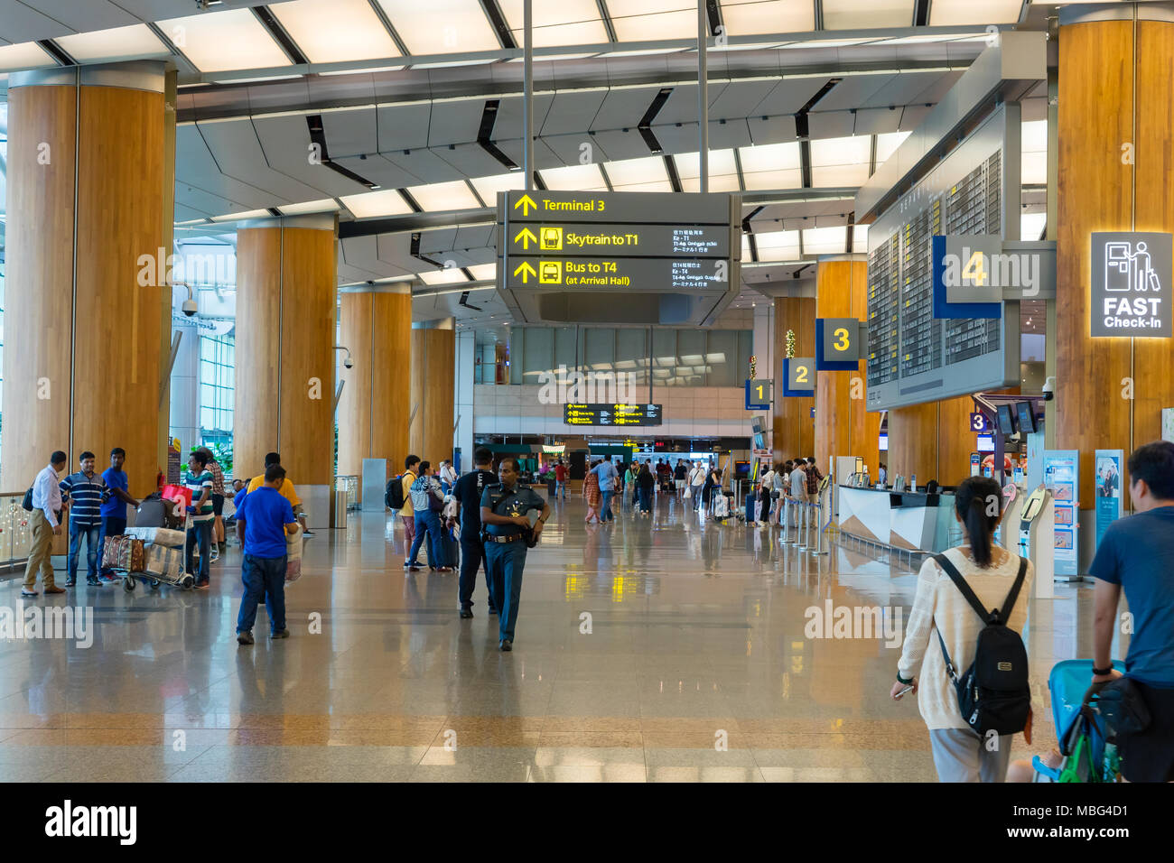 Singapore - January 6, 2018: Visitors walk around Departure Hall in Changi Airport. It has 3 passenger terminals, one of the largest transportation hu Stock Photo