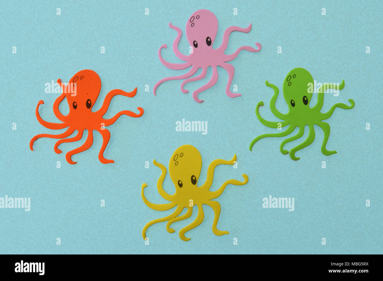 Four colorful octopus isolated on a blue background Stock Photo