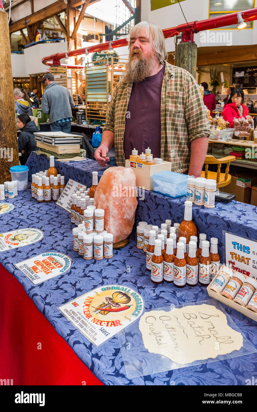 Randy of Oddball Organics, sells his garlic sauces at Granville Island Public Market, Vancouver, British Columbia, Canada. Stock Photo