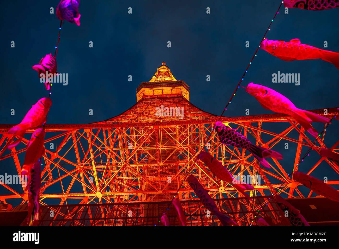 Tokyo, Japan - April 23, 2017: colorful Koinobori at Tokyo Tower by night. Koinobori are carp-shaped wind socks traditionally flown in Japan to celebrate Children's Day. Focus on Tokyo Tower. Stock Photo