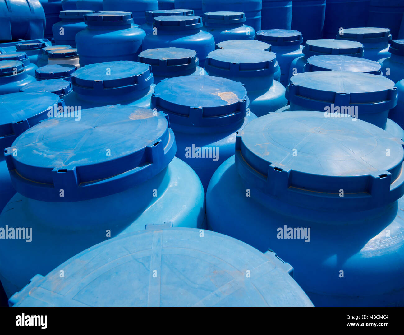 Blue plastic containers for storage of liquids in the storage area