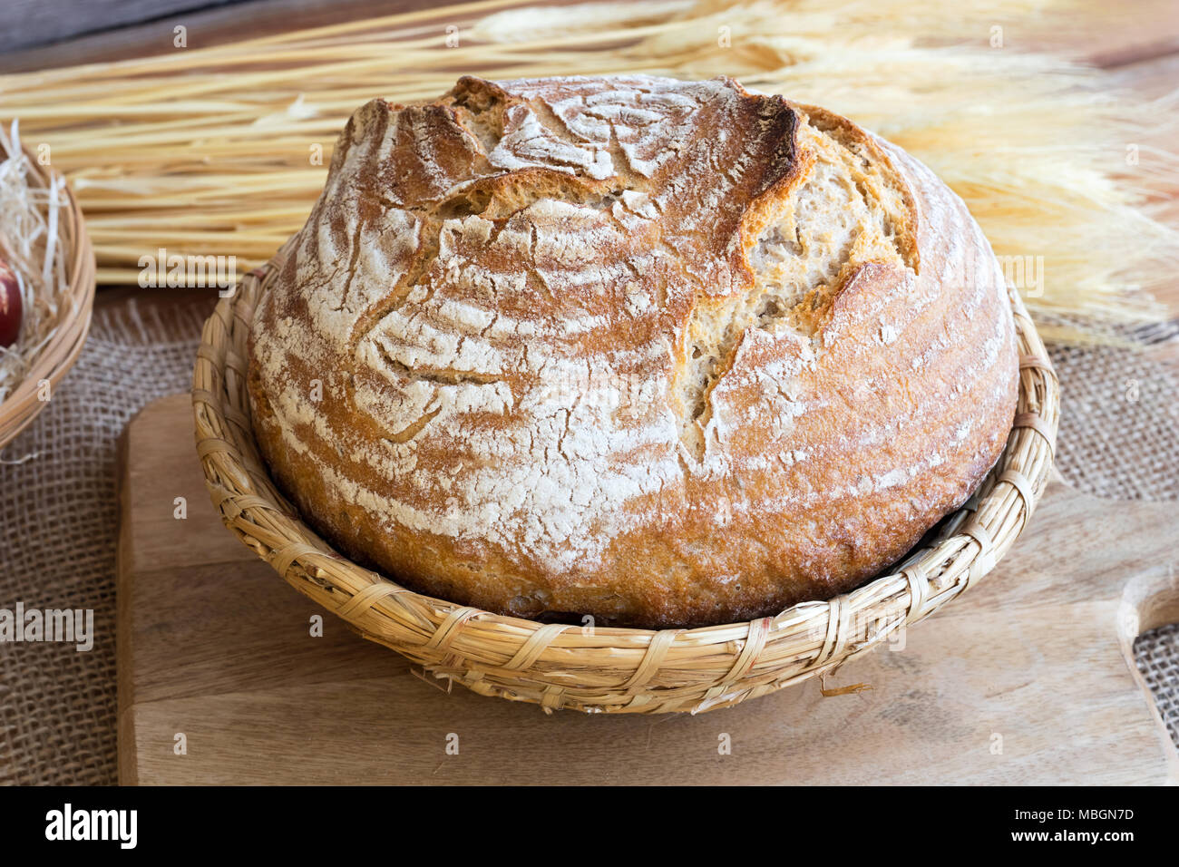 A loaf of sourdough bread in a basket Stock Photo