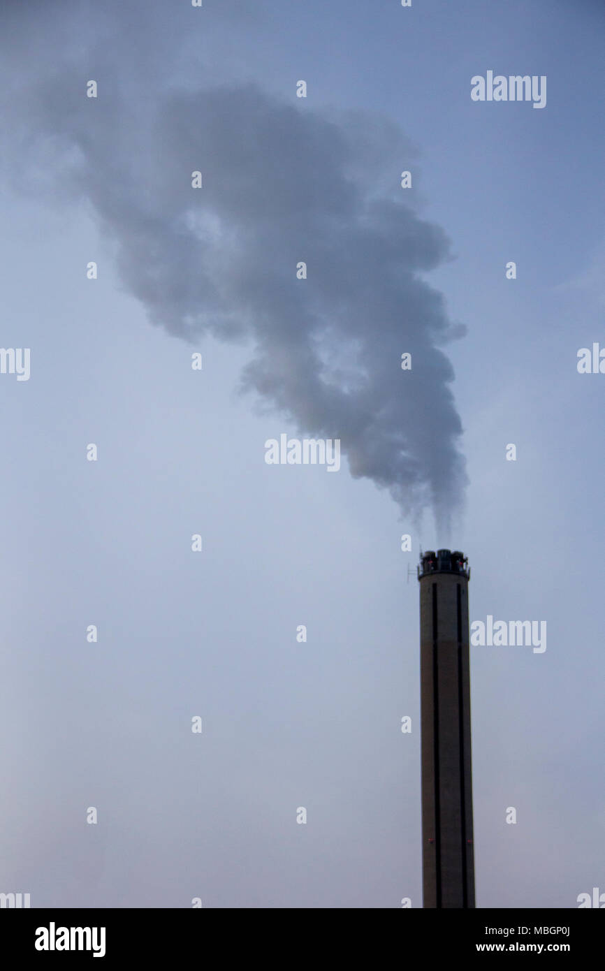 Chimney smoking stack. Air pollution and climate change theme. Poor