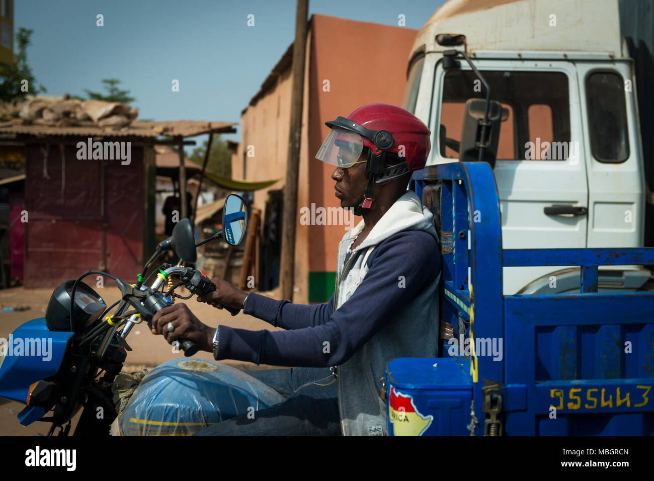 Bissau, Republic of Guinea-Bissau - January 29, 2018: Man riding his motorcycle in the city of Bissau, Guinea Bissau. Stock Photo