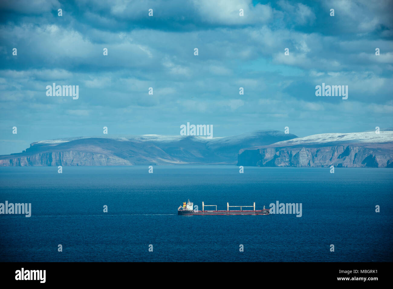 CAITHNESS, UK:  Dunnet Head, a shipping vesse passes between the UK mainland with Orkney in the background. Stock Photo