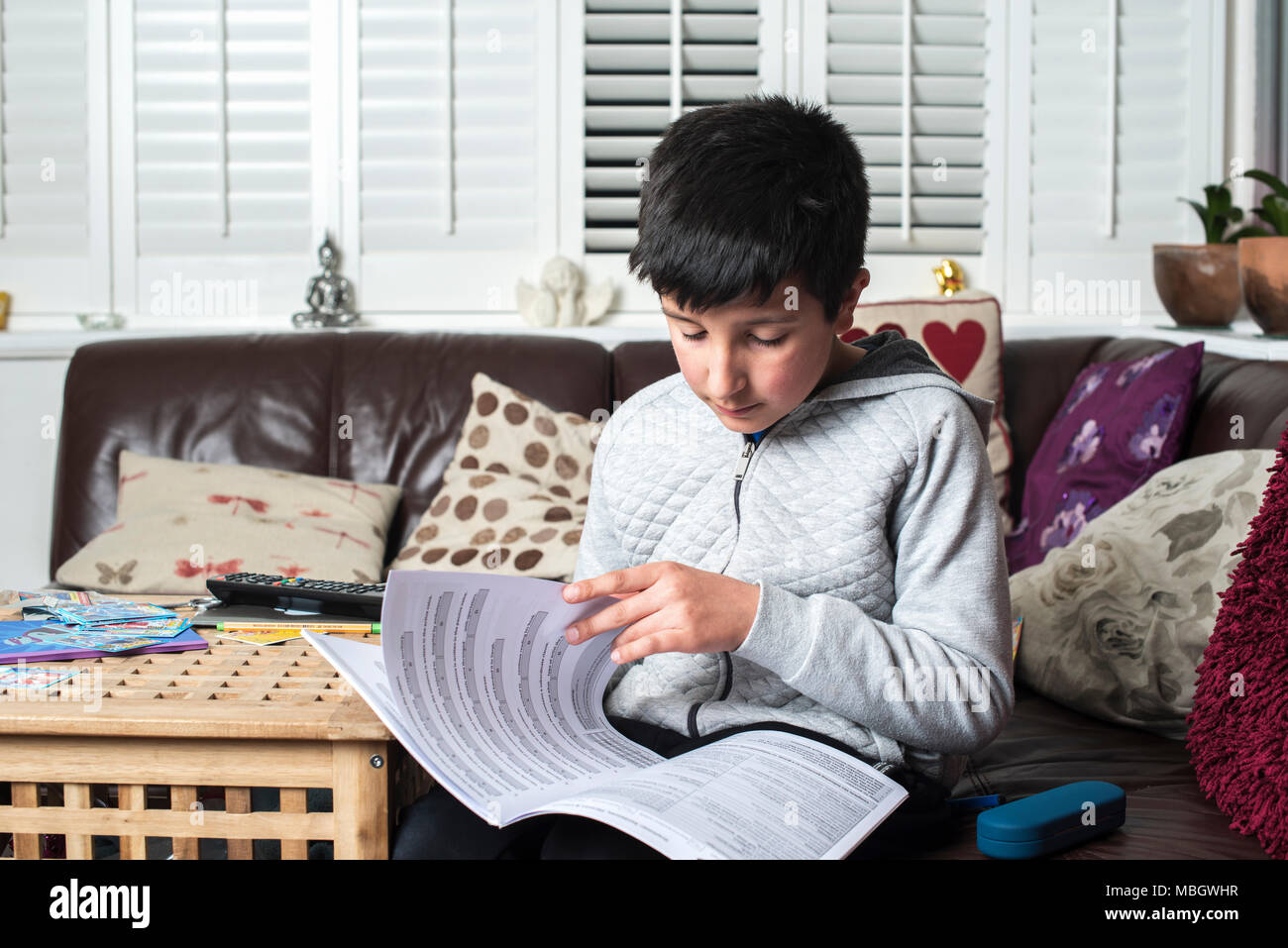 10-11 years school boy studies at home,Surrey,UK Stock Photo