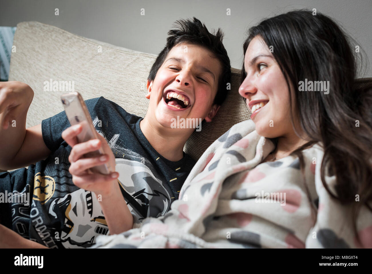 Kids watching funny videos together on smart phone Stock Photo