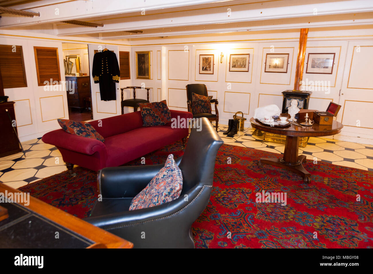 Identified by information sign as Captain 's ( quarters / rooms / lounge / reception room / suite ) on HMS Warrior. Portsmouth Historic Dockyard. UK. Stock Photo