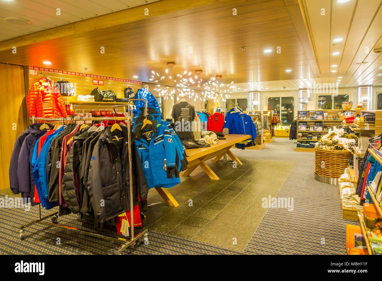 ALESUND, NORWAY - APRIL 04, 2018: Indoor view of jackets and clothes inside of small store in a KONG HARALD cruise Stock Photo