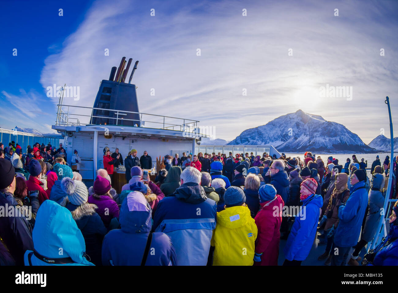 ALESUND, NORWAY - APRIL 04, 2018: Outdoor view of crowd of people in a KONG HARALD cruise enjoying and spending good time with other passengers, in Norway's coast between Bergen and Kirkenes Stock Photo
