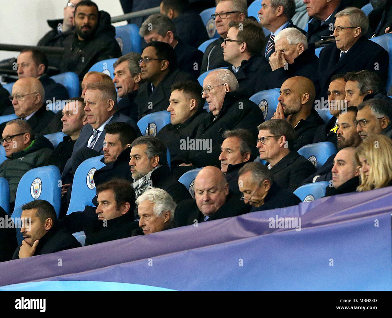 Manchester City manager Pep Guardiola (centre third right), chairman Khaldoon Al Mubarak (bottom left) and CEO Ferran Soriano (second bottom left) in the stands during the UEFA Champions League, Quarter Final at the Etihad Stadium, Manchester. Stock Photo
