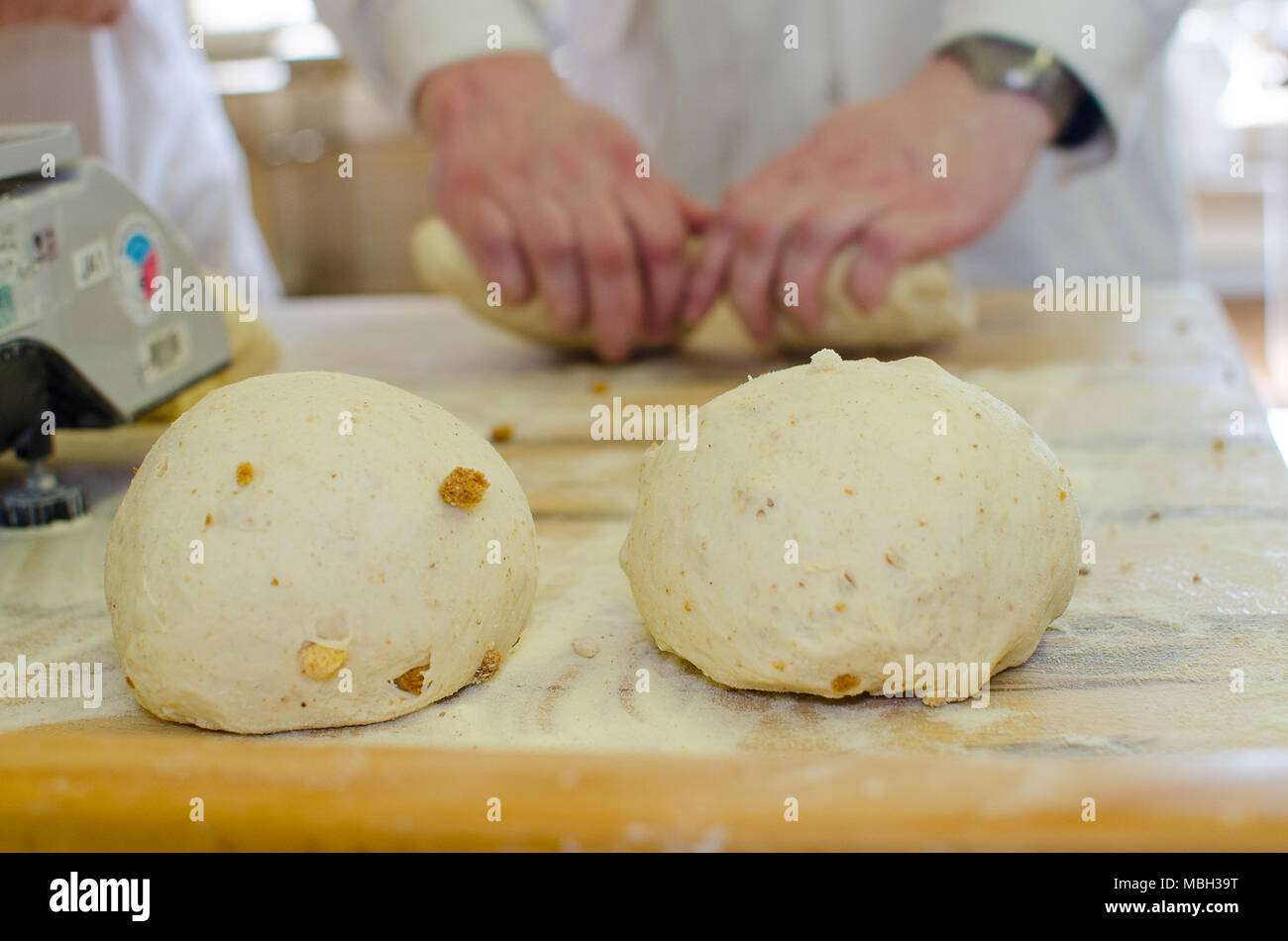 Preparing and weighing dough in a large bakery. Stock Photo