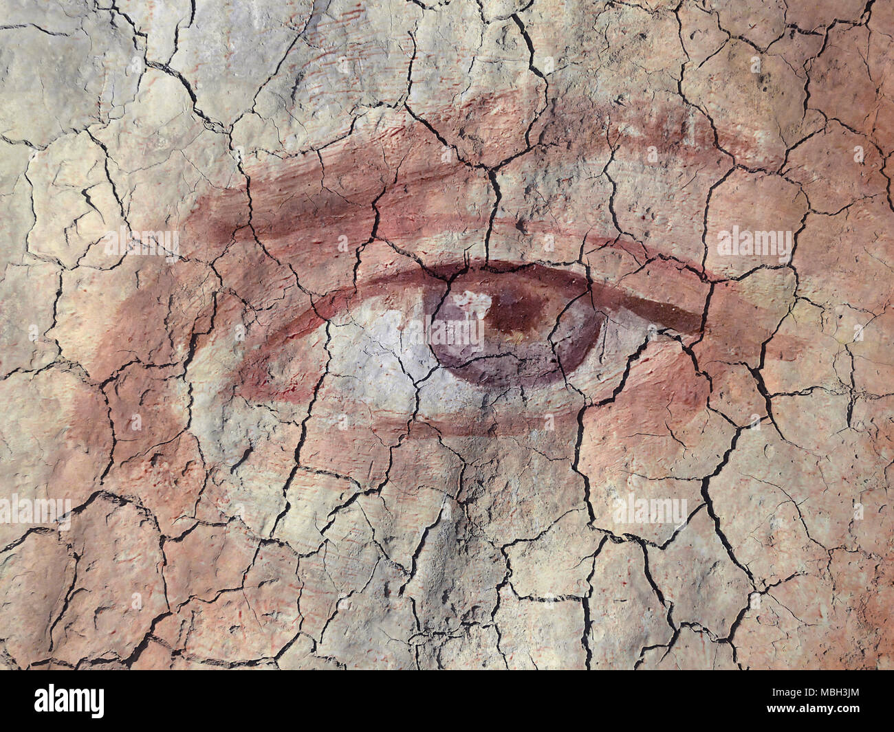 Textured and Painted Eye on Cracked earth Stock Photo