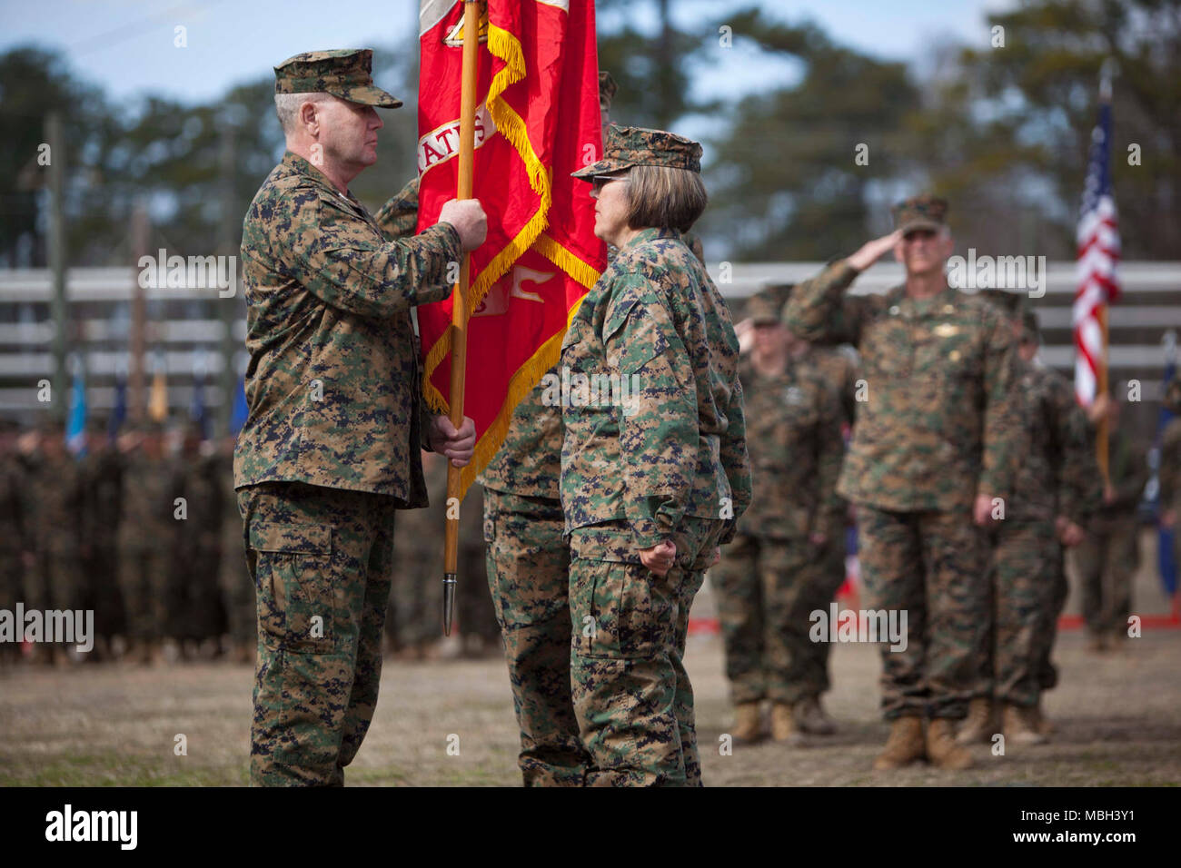 U.S. Navy Capt. Cameron L. Waggoner, left, on coming commanding officer for Field Medical Training Battalion-East (FMTB-E) receives the unit colors from Capt. Jennifer E. Smith, off going, during the FMTB-E Change of Command ceremony at Camp Johnson, N.C., Jan. 9, 2018. The change of command ceremony is a time-honered tradition in which one commander reliquishes command to another. Stock Photo