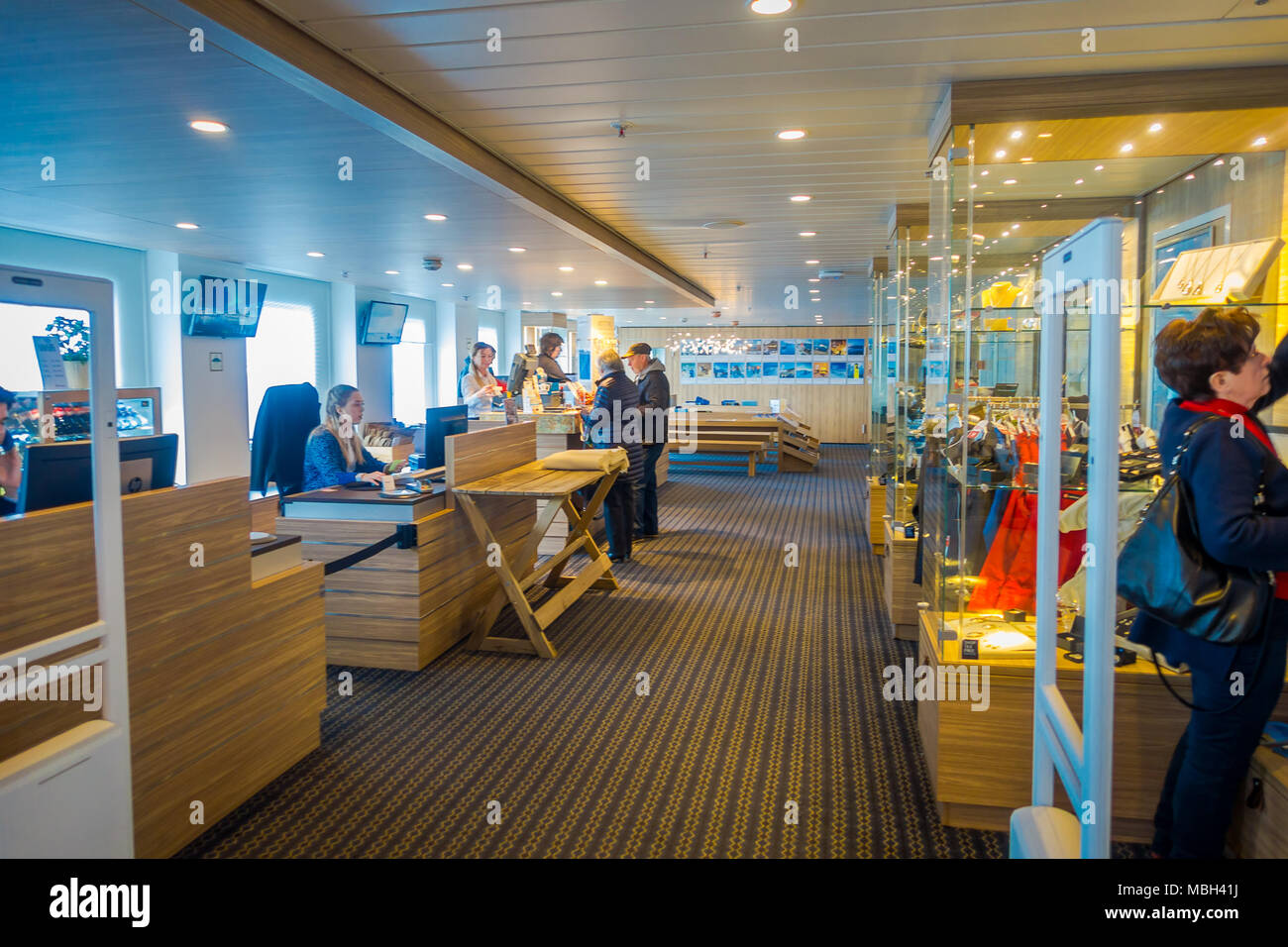 ALESUND, NORWAY - APRIL 04, 2018: Indoor view of unidentified people inside of a small store in a KONG HARALD cruise Stock Photo