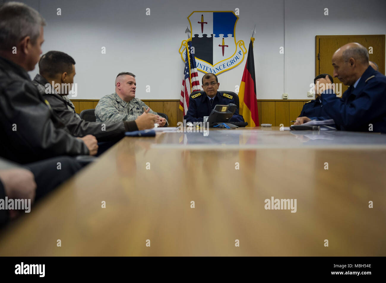 U.S. Air Force Col. Stephen Scherzer, 52nd Maintenance Group commander, briefs Maj. Gen. Hassan Fakri, Royal Moroccan Air Force deputy inspector, about the various planning and scheduling processes of the 52nd MXG at Spangdahlem Air Base, Germany, March 28, 2018. During the visit, senior leaders from the RMAF learned best practices from the MXG in order to better facilitate and operate their F-16 flying mission. Stock Photo