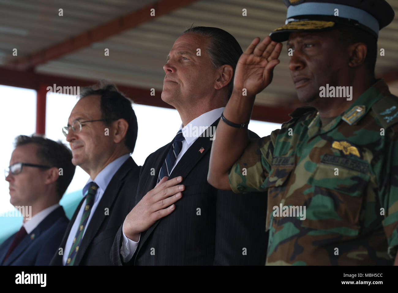 Daniel L. Foote, U.S. Ambassador to the Republic of Zambia, stands while the Zambian Army Band plays the American National Anthem during the closing ceremonies of ZAMBAT IV, Nanking Peace Mission Training Center, Lusaka, Zambia, March 29, 2018.Training modules included: marksmanship, mounted battle drills, training alongside Indian Army counterparts for battlefield trauma, cordon and search, and convoy operations with British soldiers. Zambian Infantry soldiers rehearsed tactics and real-world scenarios likely to be encountered while serving in support of the United Nations Multidimensional St Stock Photo