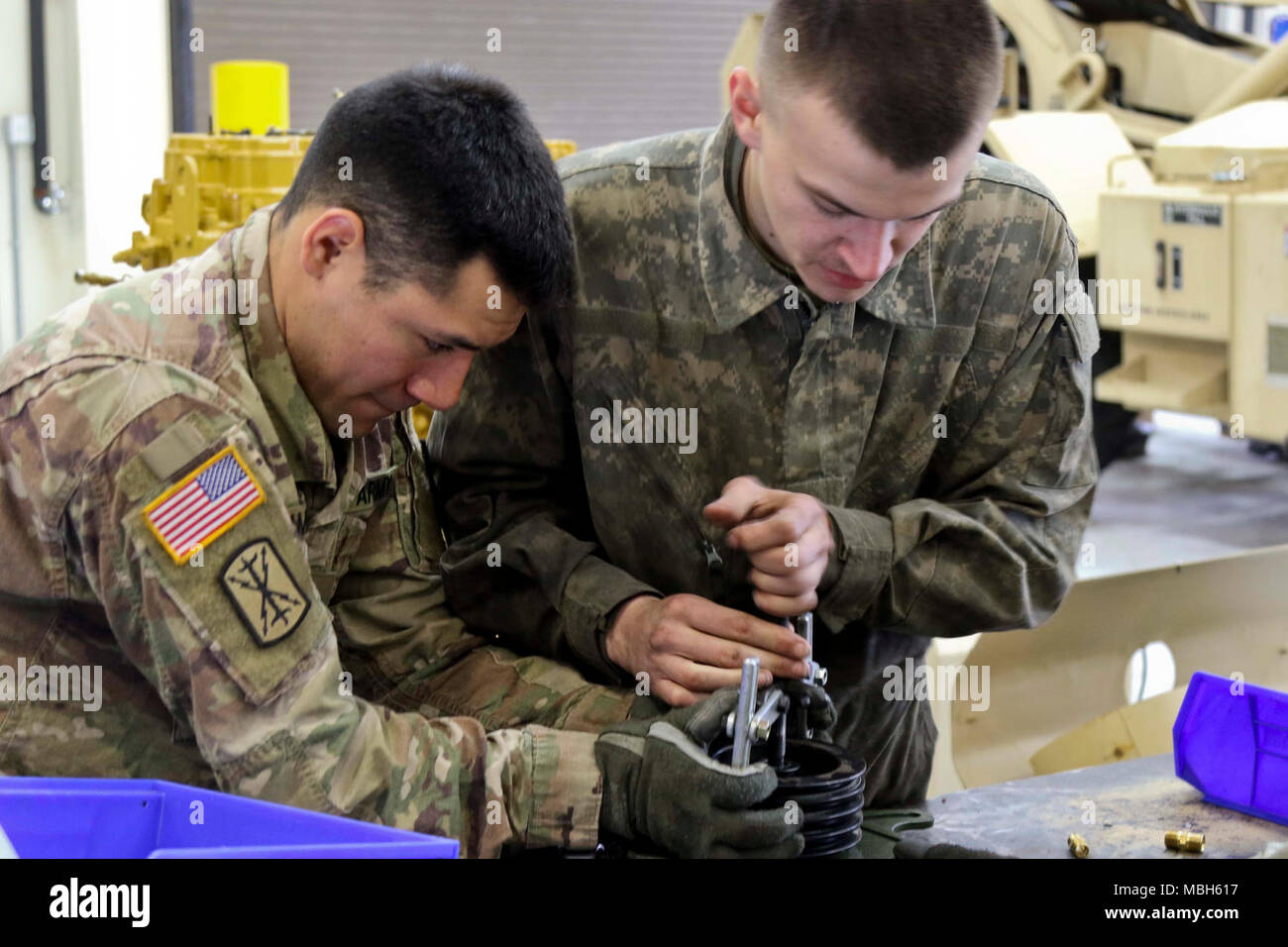 Spc. Moses Amesquita, Headquarters, Headquarters Battery, 17th Field Artillery Brigade, holds a power steering pump steady while Pvt. Curtis Streff, Headquarters Support Company, 308th Brigade Support Battalion, works on repairing the part for Amesquita’s truck on Joint Base Lewis-McChord, Wash. Apr. 3, 2018. 17th FA Bde. conducts a 550 mile convoy training from JBLM to Orchard Combat Training Center, Idaho between Apr. 3-9. (US Army Stock Photo