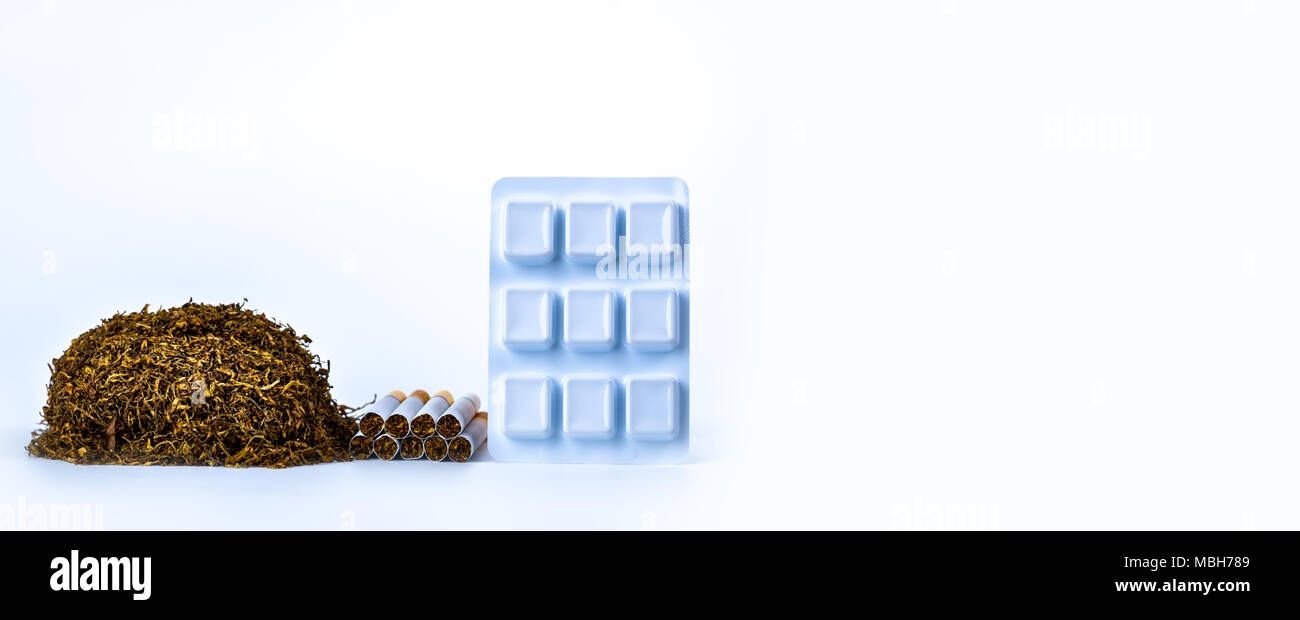 Nicotine chewing gum in blister pack near pile of cigarette. Quit